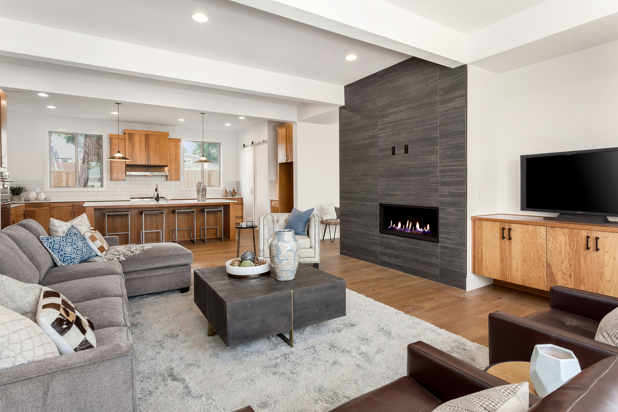 Living room with modern fireplace and open kitchen